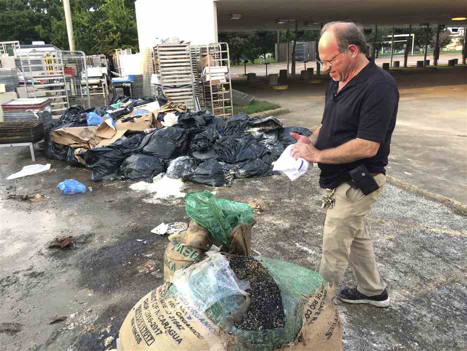 Robert Jucker begins post-hurricane cleanup behind the bakery.