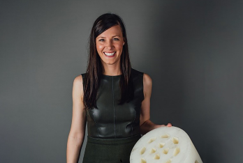 Samantha Snabes holds a 3D-printed product.