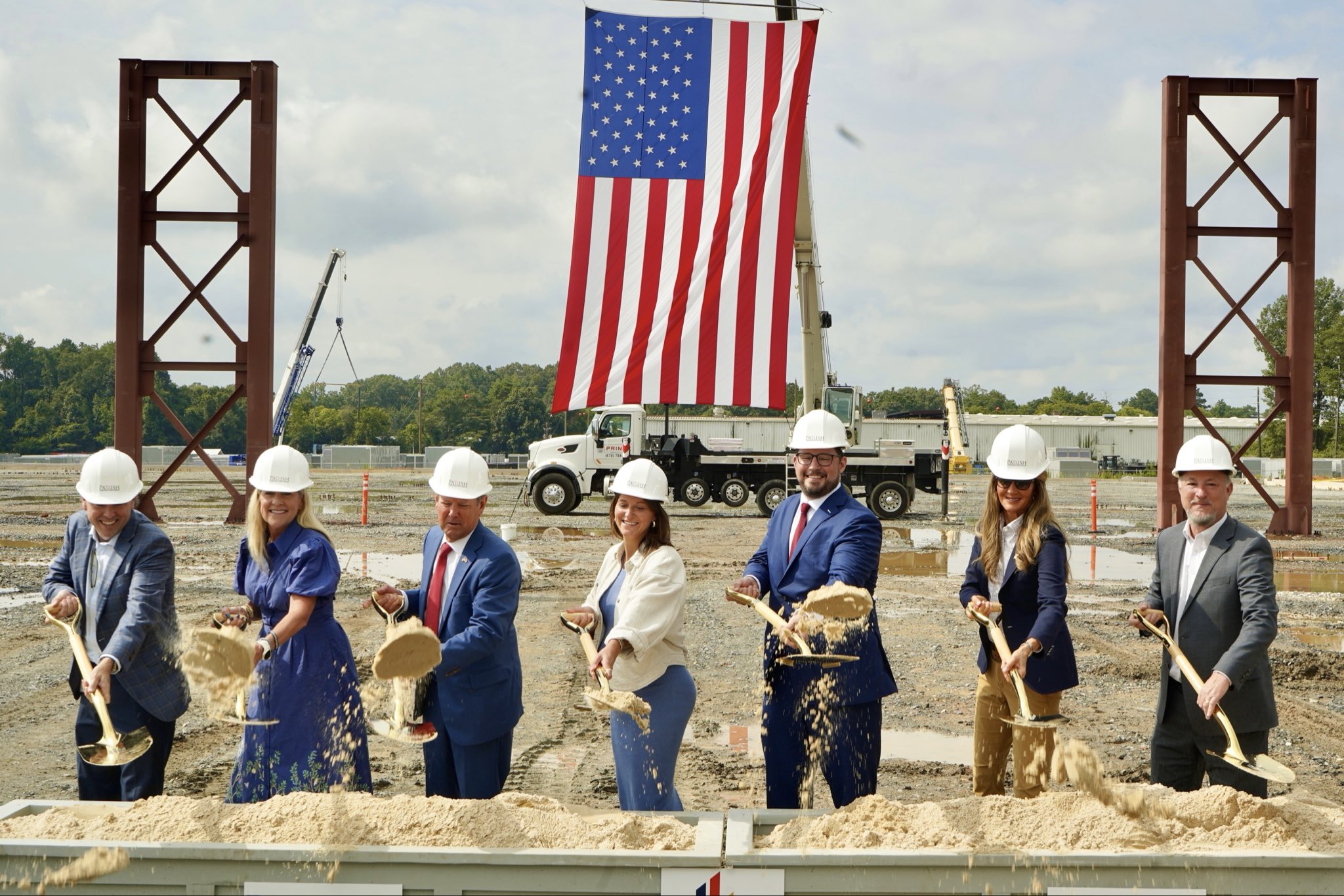 Administrator Loeffler and others in a ceremonial ground-breaking using gold shovels