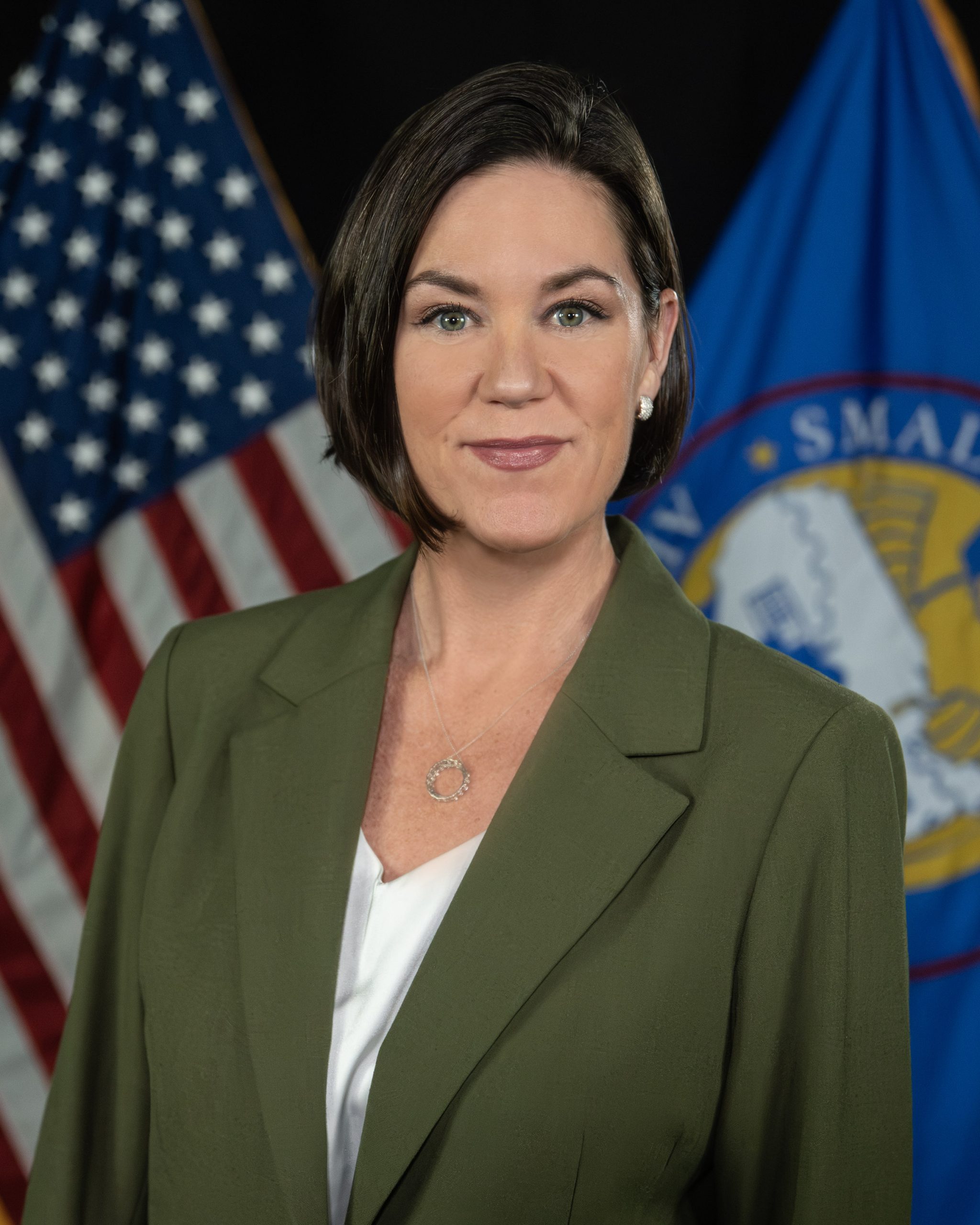 Annie Spillman in front of U.S. and SBA flags.
